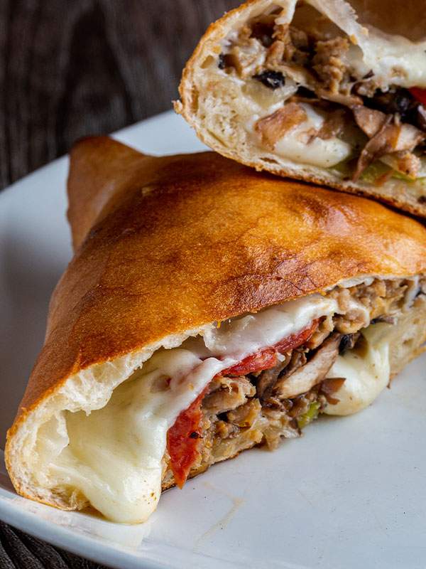 Calzone with peppers, onions, and meat